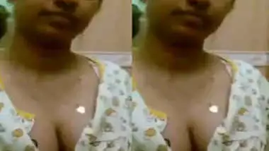 Indian sex whore pulls her shirt a bit down showing off round XXX tits